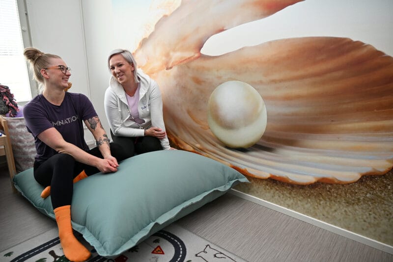 Tukena Hippenhelmi ”Jokainen lapsi on meille helmi, jonka vanhemmat antavat hoivaamme”, Leena Aaltonen sanoo. Seinämaalauksen äärellä hänen kanssaan Stina Mäkitalo.